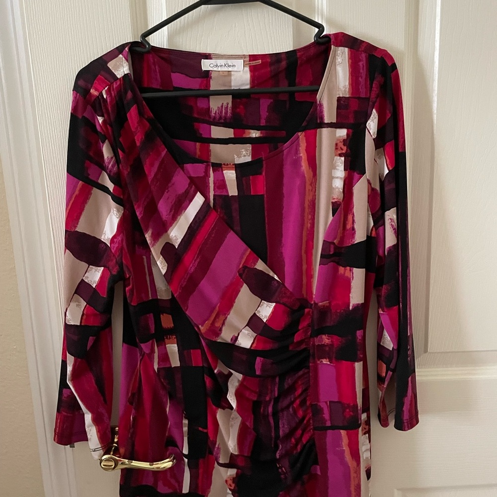 Calvin Klein woman’s faux wrap top size L in red, pink, black.